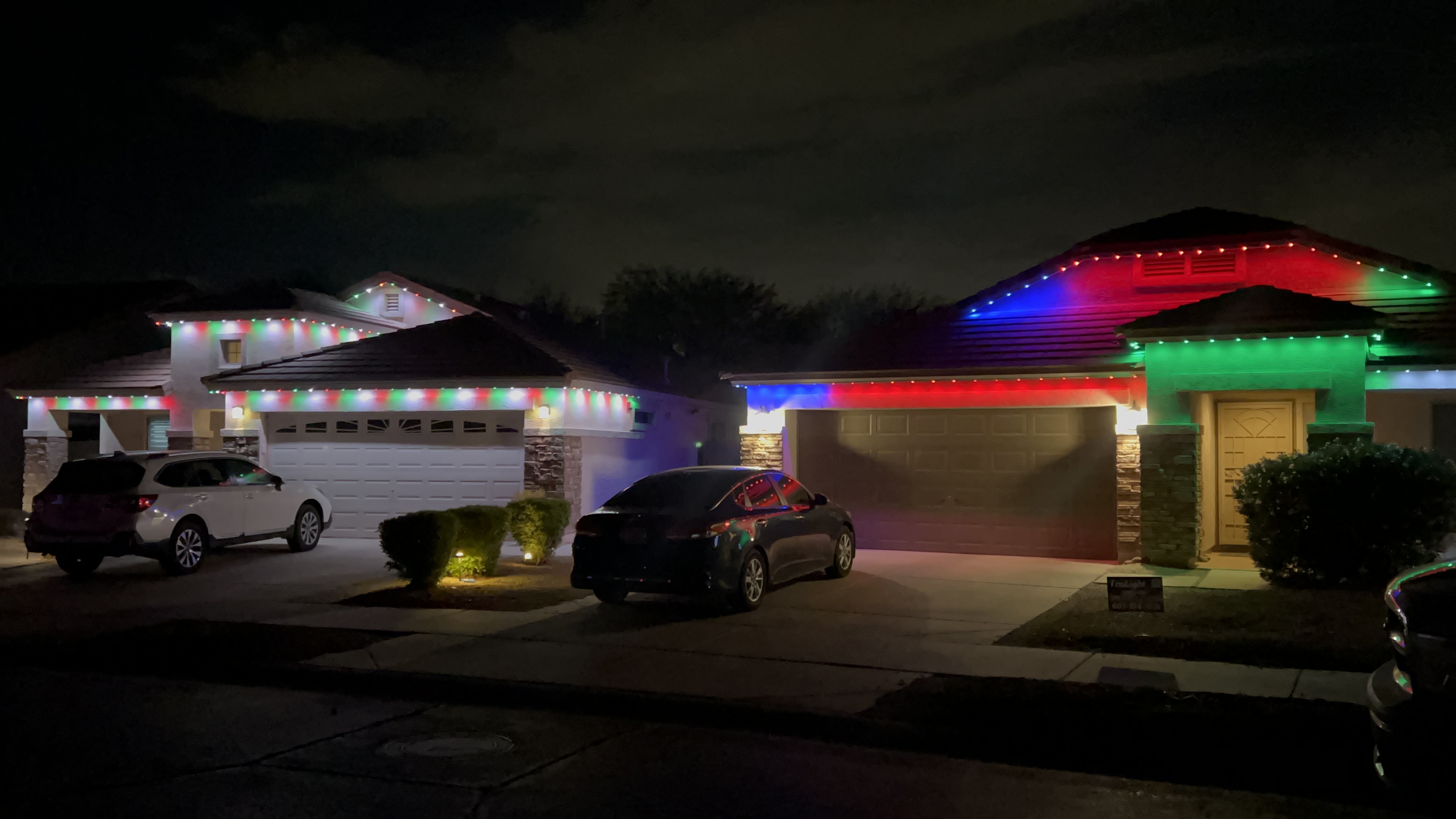 TruLight example of homes illuminated with colorful holiday roofline lighting
