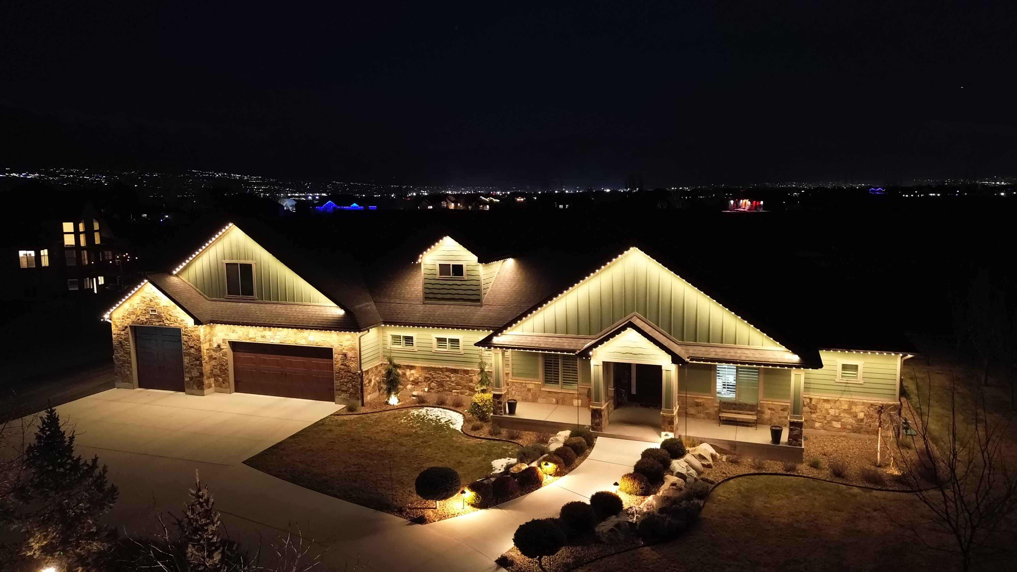 TruLight white roofline lights illuminating a home exterior